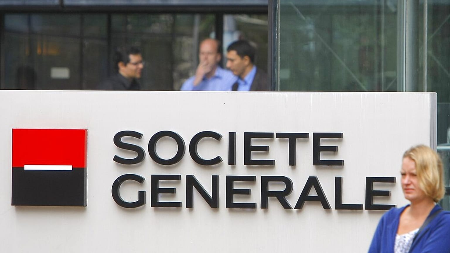 FILE - In this 11 August 2011 file photo, employees stand at the entrance of the Societe General bank headquarters in Paris.