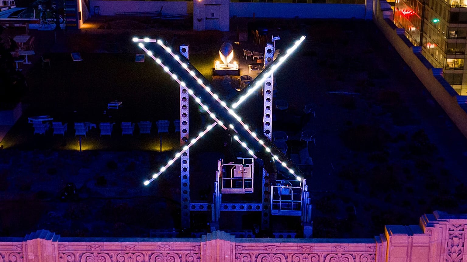 File - Workers install lighting on an "X" sign atop the company headquarters, formerly known as Twitter, in San Francisco, on July 28, 2023. 