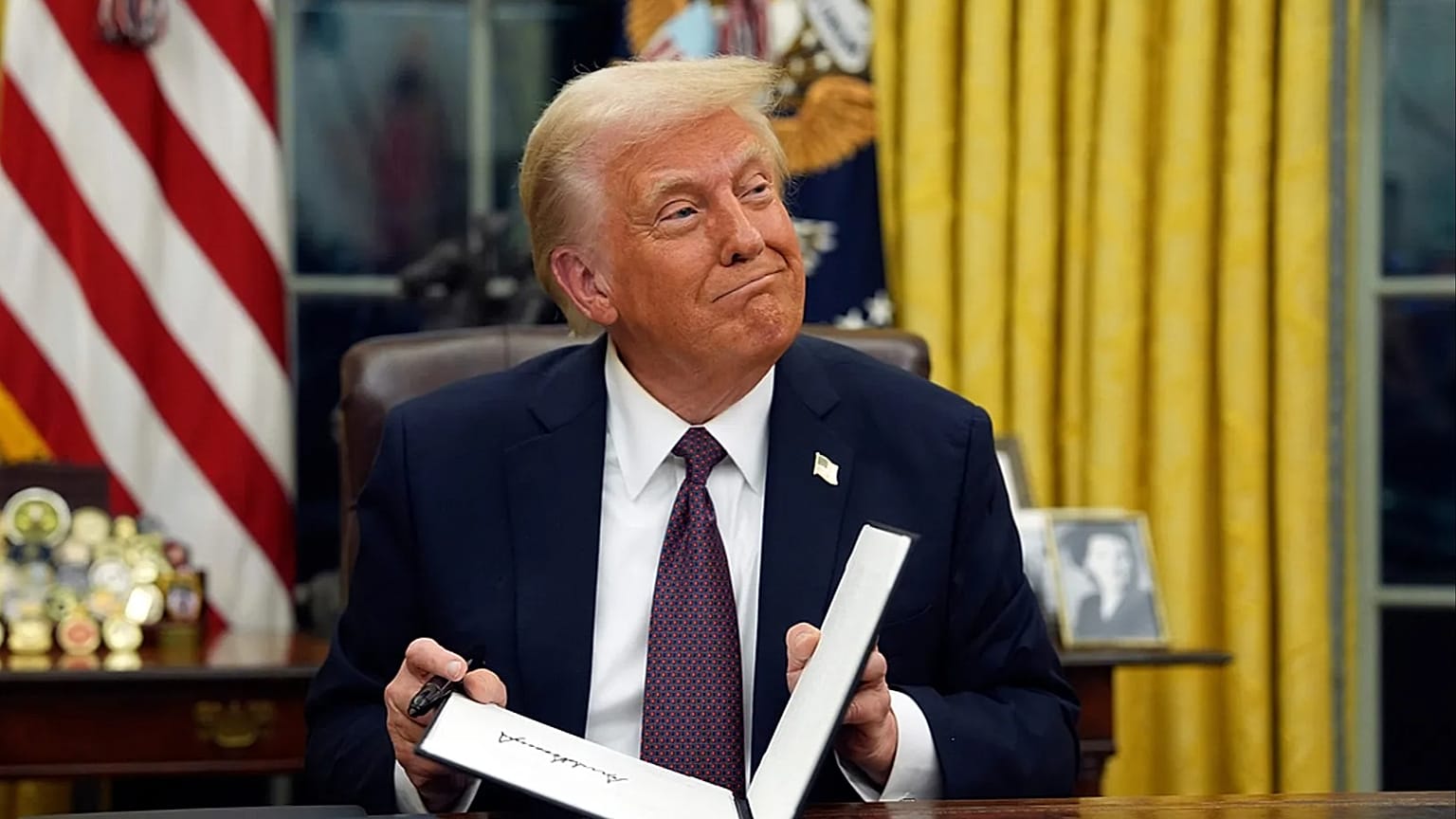 FILE - President Donald Trump signs executive orders in the Oval Office of the White House, 20 Jan. 2025, in Washington