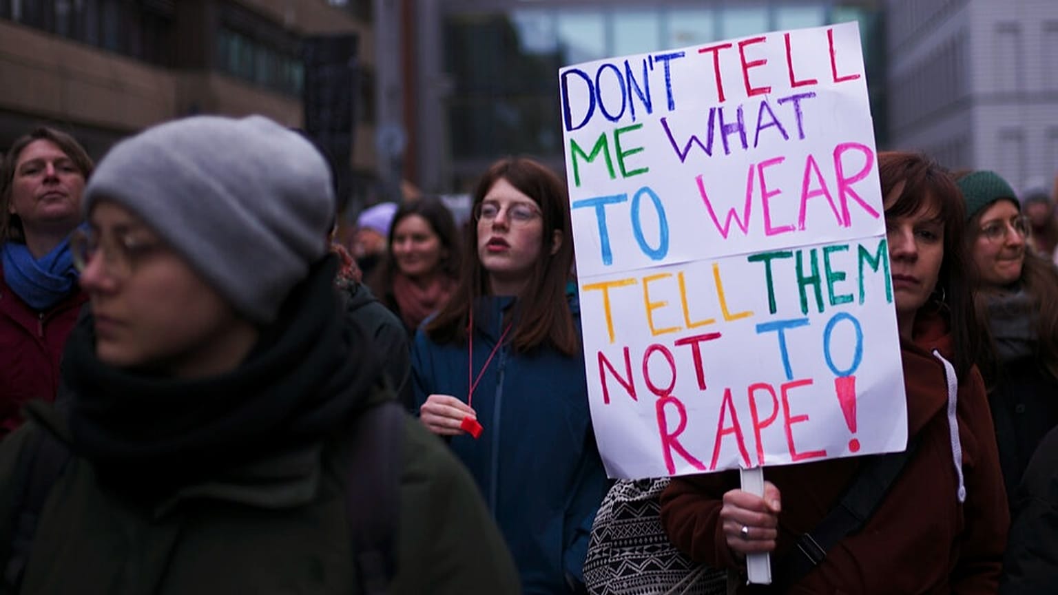 FILE - A woman shjows a poster as she attends a rally marking International Women's Day 2023 in Berlin, Germany, Wednesday, 8 March 2023.