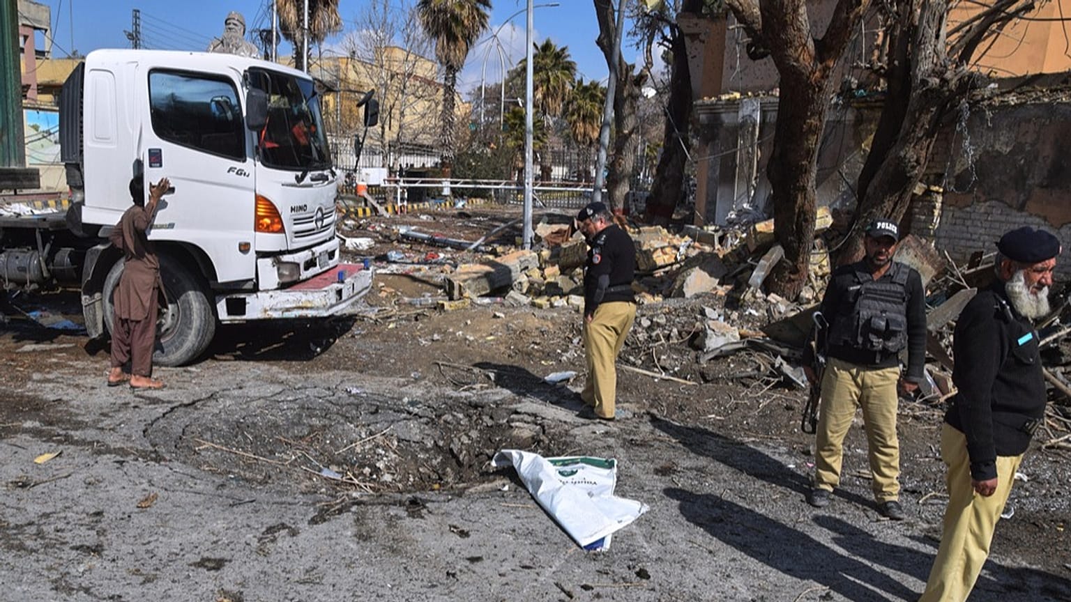 Police officers examine the site of Saturday's suicide bombing, in Quetta, Pakistan, Sunday, Feb. 1, 2026