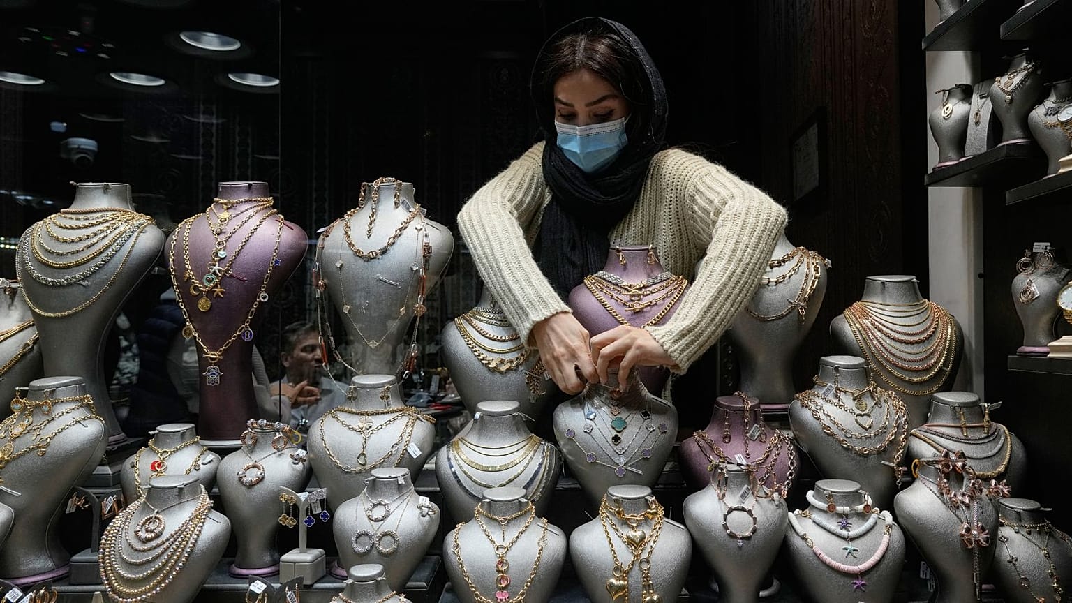 FILE. A goldsmith arranges necklaces at the window of a gold shop at a gold market in Tehran's Grand Bazaar, Iran. 29 Nov. 2025