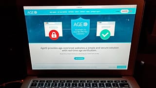 File - This photo taken in London on Monday July 8, 2019, shows a laptop screen displaying the website for AgeID, an age verification system. 