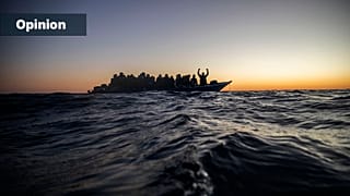 FILE: Migrants and refugees wait for assistance on an overcrowded wooden boat in the Mediterranean Sea off the Libyan coast, 12 February 2021