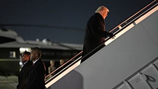President Donald Trump boards Air Force One for a trip to attend the World Economic Form in Davos, Tuesday, Jan. 20, 2026, at Joint Base Andrews