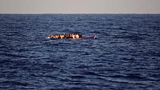 Migrants and refugees fleeing Libya on board of a wooden boat sail at the Mediterranean sea toward the Italian coasts, about 17 miles north of Sabratha, Libya, Sunday, Aug. 28