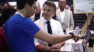 French President Emmanuel Macron discusses with exhibitorsas he visits the Vivatech exhibition in Paris, Wednesday, June 14, 2023. Europe's biggest startup and tech event.
