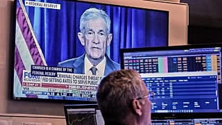 A video of Federal Reserve Chair Jerome Powell plays on a screen on the floor of the New York Stock Exchange, 12 January, 2026