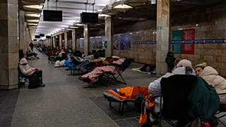 People take shelter in a metro station, being used as a bomb shelter, during a Russian drones attack in Kyiv