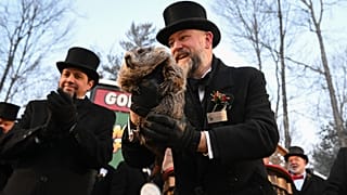 Groundhog Club handler A.J. Dereume holds Punxsutawney Phil, the weather prognosticating groundhog