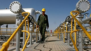 FILE. Iranian oil technician Majid Afshari makes his way at the oil separator facilities in Azadegan oil field, near Ahvaz, Iran. 15 April 2008
