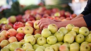 Apples are displayed at a farmers' market.