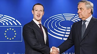 FILE. Former European Parliament President Antonio Tajani, right, welcomes Facebook CEO Mark Zuckerberg upon his arrival at the EU Parliament in Brussels. 22 May 2018. 