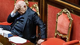 Justice Minister Carlo Nordio  puts his hand to his head during the presentation of the report on the justice administration, at the Senate, in Rome, Wednesday, Jan. 22, 2025