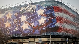 FILE: A billboard depicting a damaged US aircraft carrier with disabled fighter jets on its deck is seen at Islamic Revolution Square in Tehran, 25 January 2026