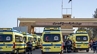 Ambulances line up to enter the Egyptian gate of the Rafah crossing on the way to the Gaza Strip, in Rafah