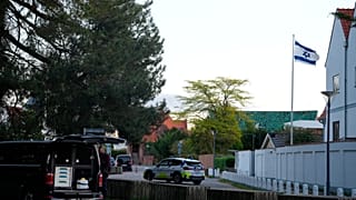 FILE: A police vehicle is seen near the Israeli embassy in Copenhagen, as police investigate two explosions near the site, on Wednesday, Oct. 2, 2024.
