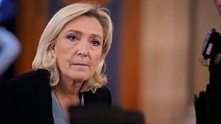RN leader Marine Le Pen leaves the courtroom during a short break in her appeal trial in Paris. 