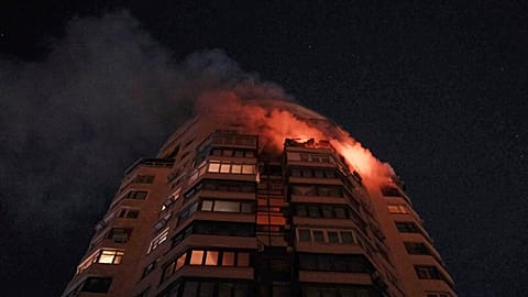 Emergency services personnel work to extinguish a fire at a multi-storey apartment building following a Russian attack in Kyiv, 3 February 2026
