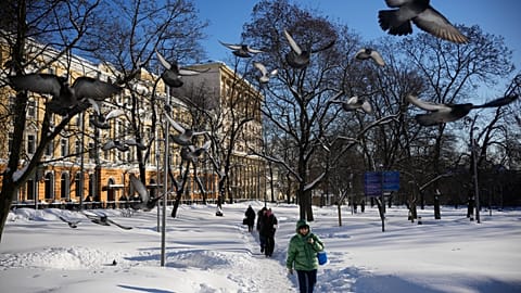 People walk along Red Square on a frosty day in Moscow, Friday, Jan. 30, 2026