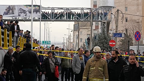 People gather as they watch a fire raging at the Jannat market in western Tehran