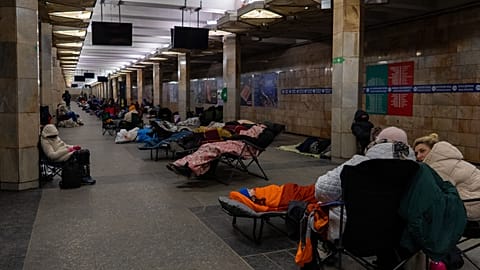 People take shelter in a metro station, being used as a bomb shelter, during a Russian drones attack in Kyiv