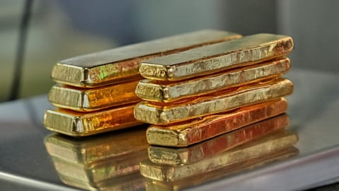 FILE. A gold jeweler weighs gold bars for sale in Bangkok, Thailand. 29 Jan. 2026.