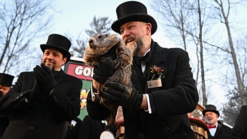 Groundhog Club handler A.J. Dereume holds Punxsutawney Phil, the weather prognosticating groundhog
