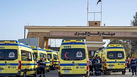 Ambulances line up to enter the Egyptian gate of the Rafah crossing on the way to the Gaza Strip, in Rafah