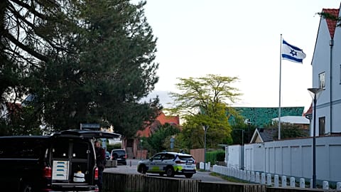 FILE: A police vehicle is seen near the Israeli embassy in Copenhagen, as police investigate two explosions near the site, on Wednesday, Oct. 2, 2024.